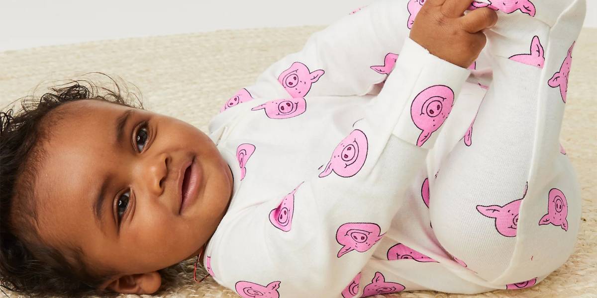 Baby wearing Percy Pig sleepsuit 